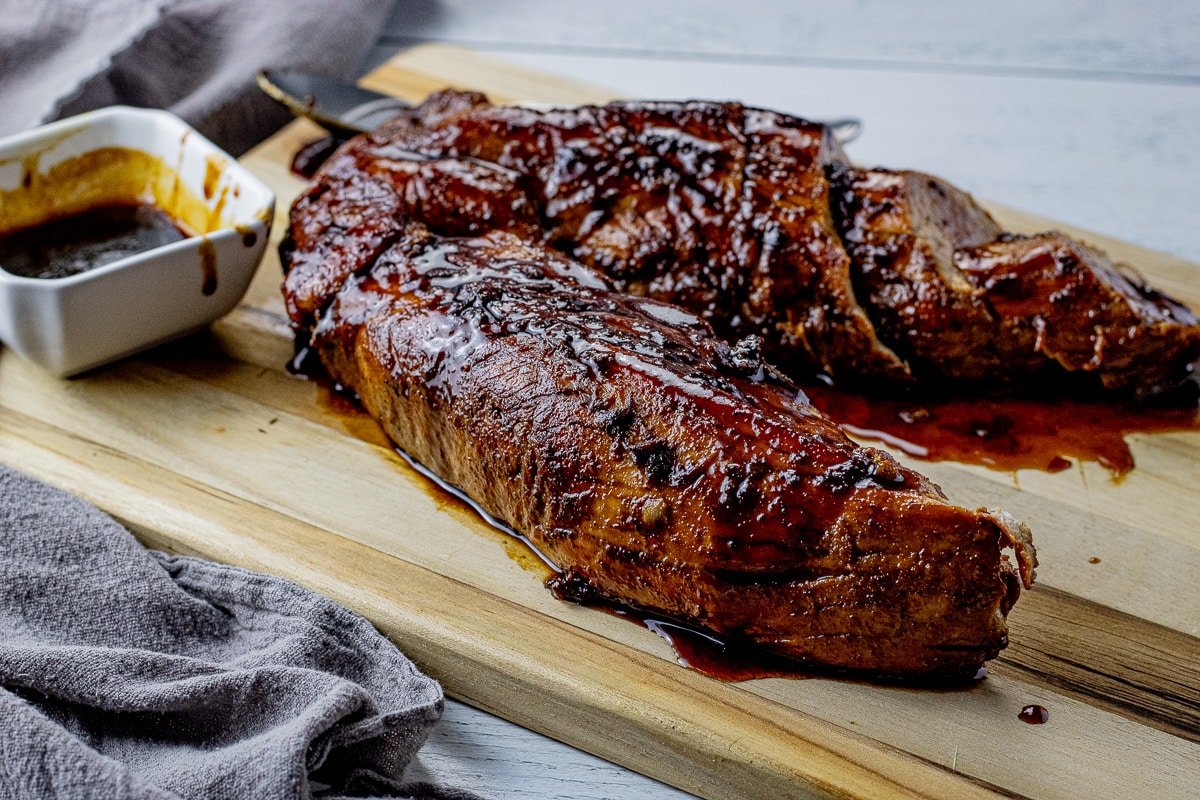 two pork tenderloins topped with a dark glaze