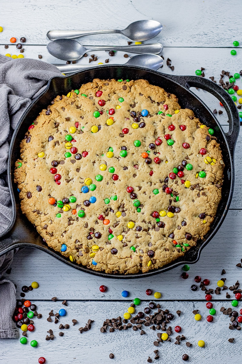 cast iron pan filled with a chocolate chip and m and m cookie
