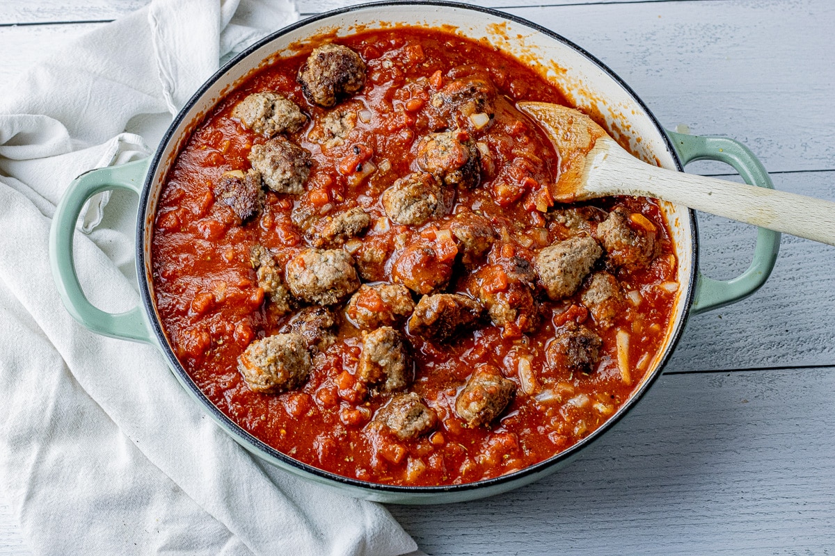 spaghetti sauce with meatballs in a large round pan