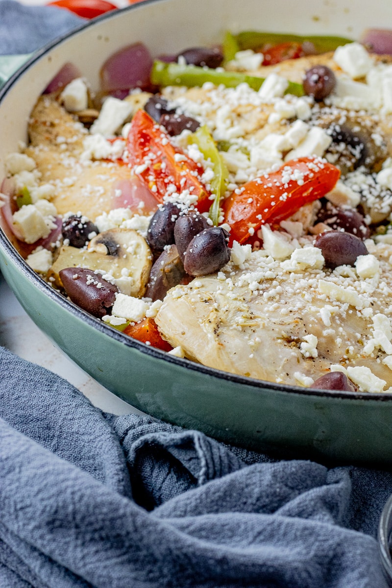 cast iron pan with chicken, tomatoes, green peppers, kalamata olives and feta cheese