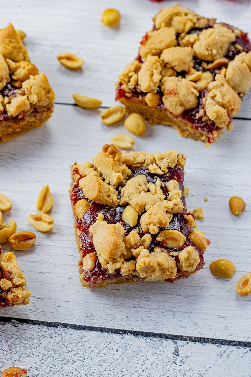 The classic flavor combination of Peanut Butter and Jelly are combined to make this super rich and delicious dessert bar. Imagine a buttery, peanut butter crust, topped with your favorite jam then topped again with more peanut butter goodness.