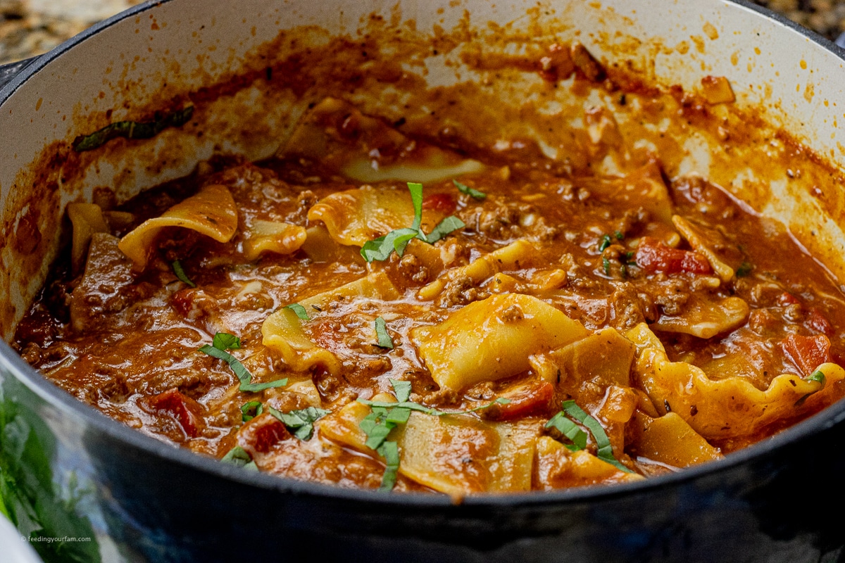 lasagna soup with cooked lasagna noodles and fresh chopped basil on top