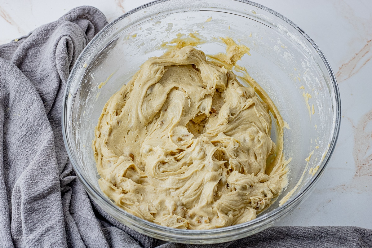 maple cake batter with walnuts in a mixing bowl