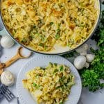 tuna casserole in a large skillet with a little on a white, round plate