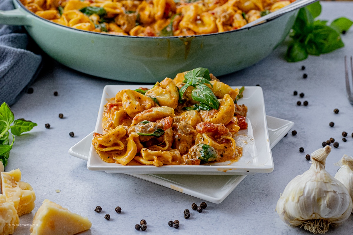 summer tortellini skillet recipe with sausage and spinach in a skillet