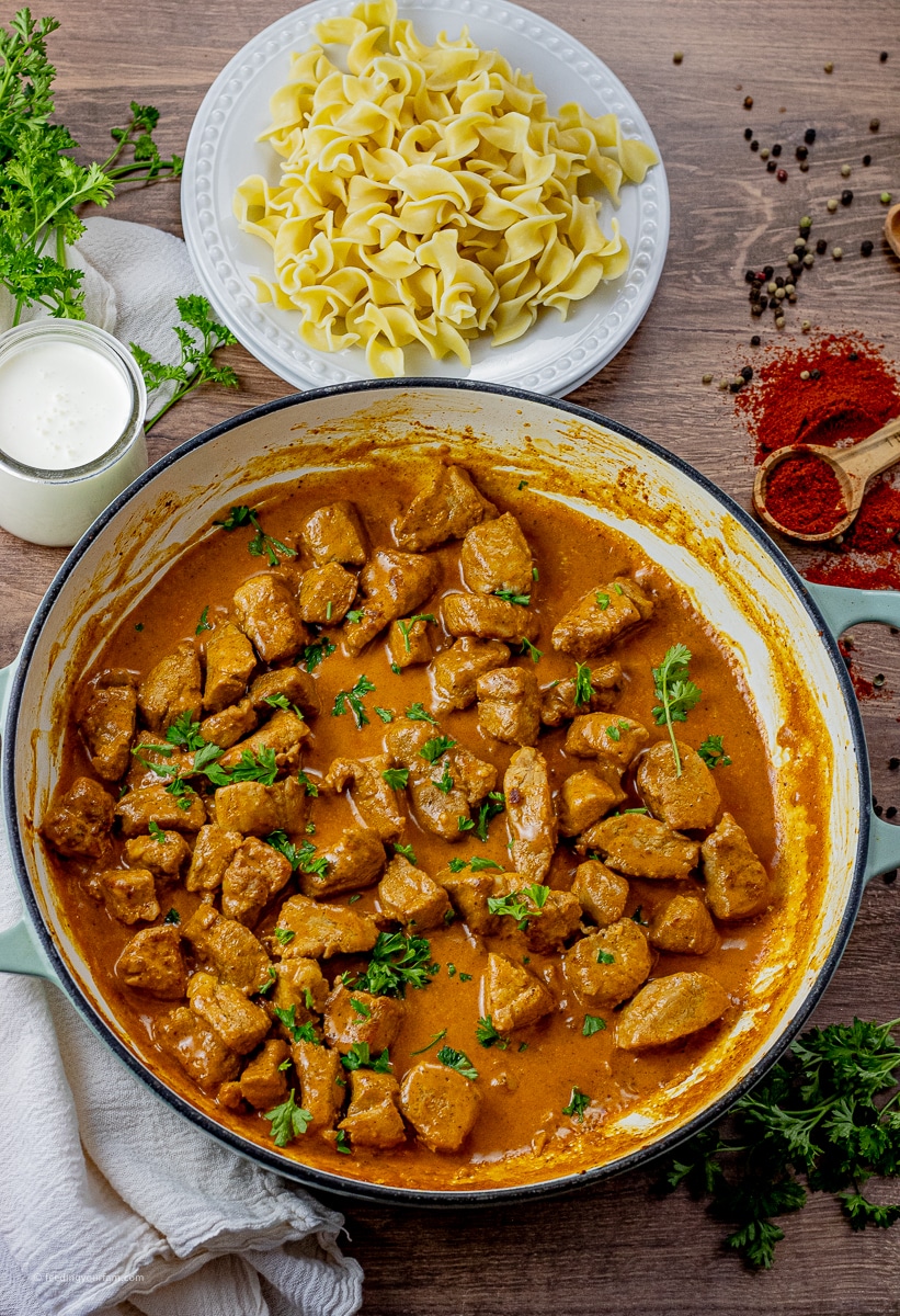 pieces of pork tenderloin in a sauce made with cream and paprika