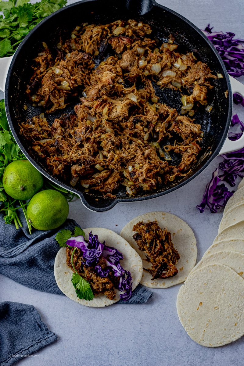 simple pulled pork tacos cast iron pan filled with pulled pork to make tacos