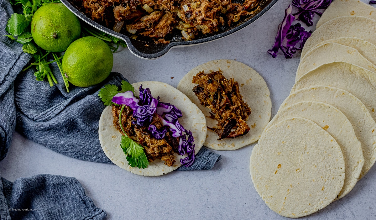 Simple pulled pork tacos pulled pork tacos topped with red cabbage and cilantro
