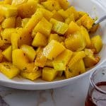 roasted pieces of butternut squash in a white bowl