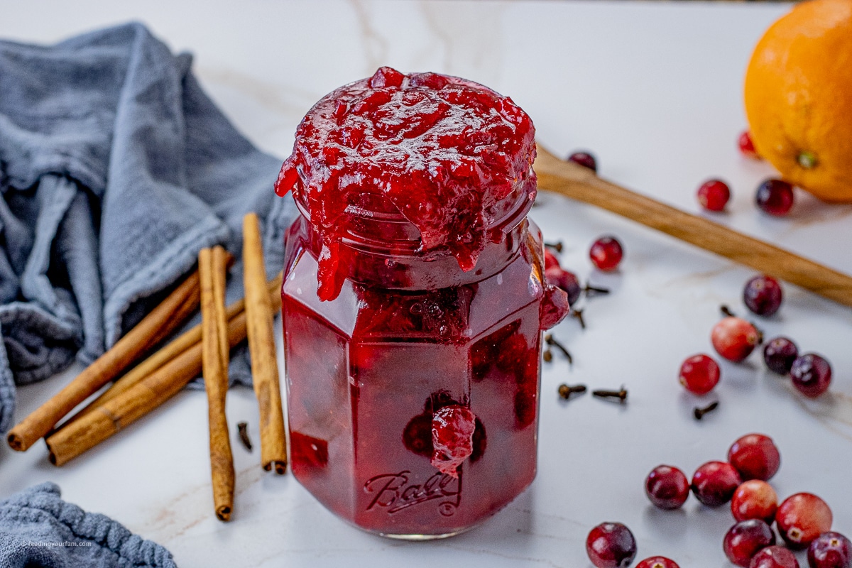 jar filled to spilling over with cranberry orange sauce