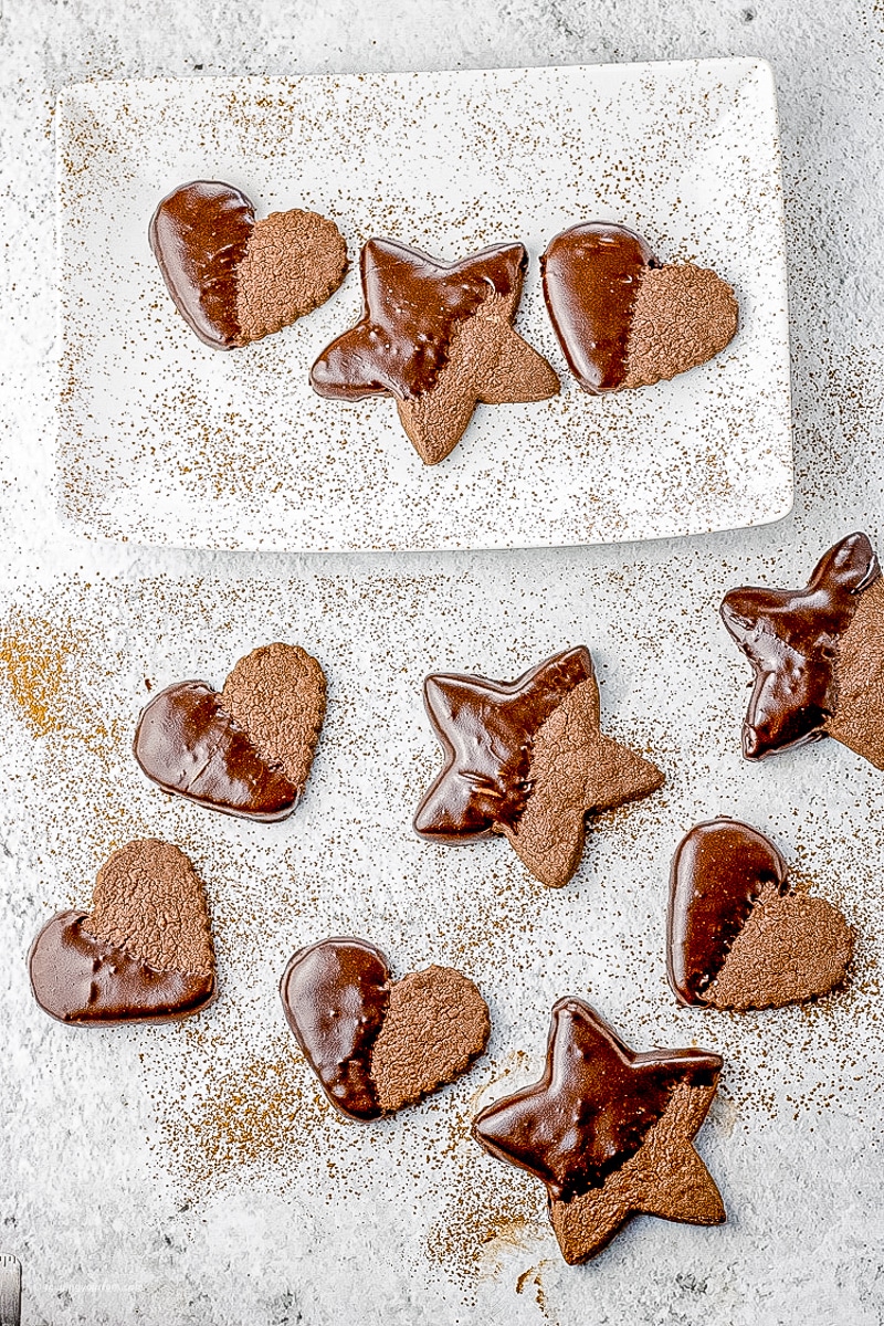 chocolate cookies shaped into hearts and stars and half dipped into chocolate