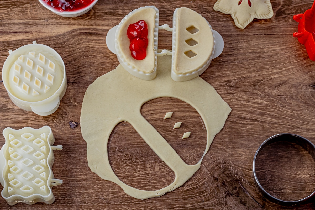 pie dough cut out in a half moon shape to make mini pie