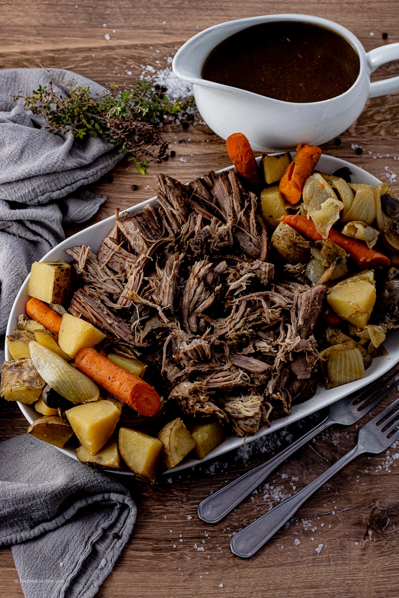 shredded beef with vegetables on white serving platter
