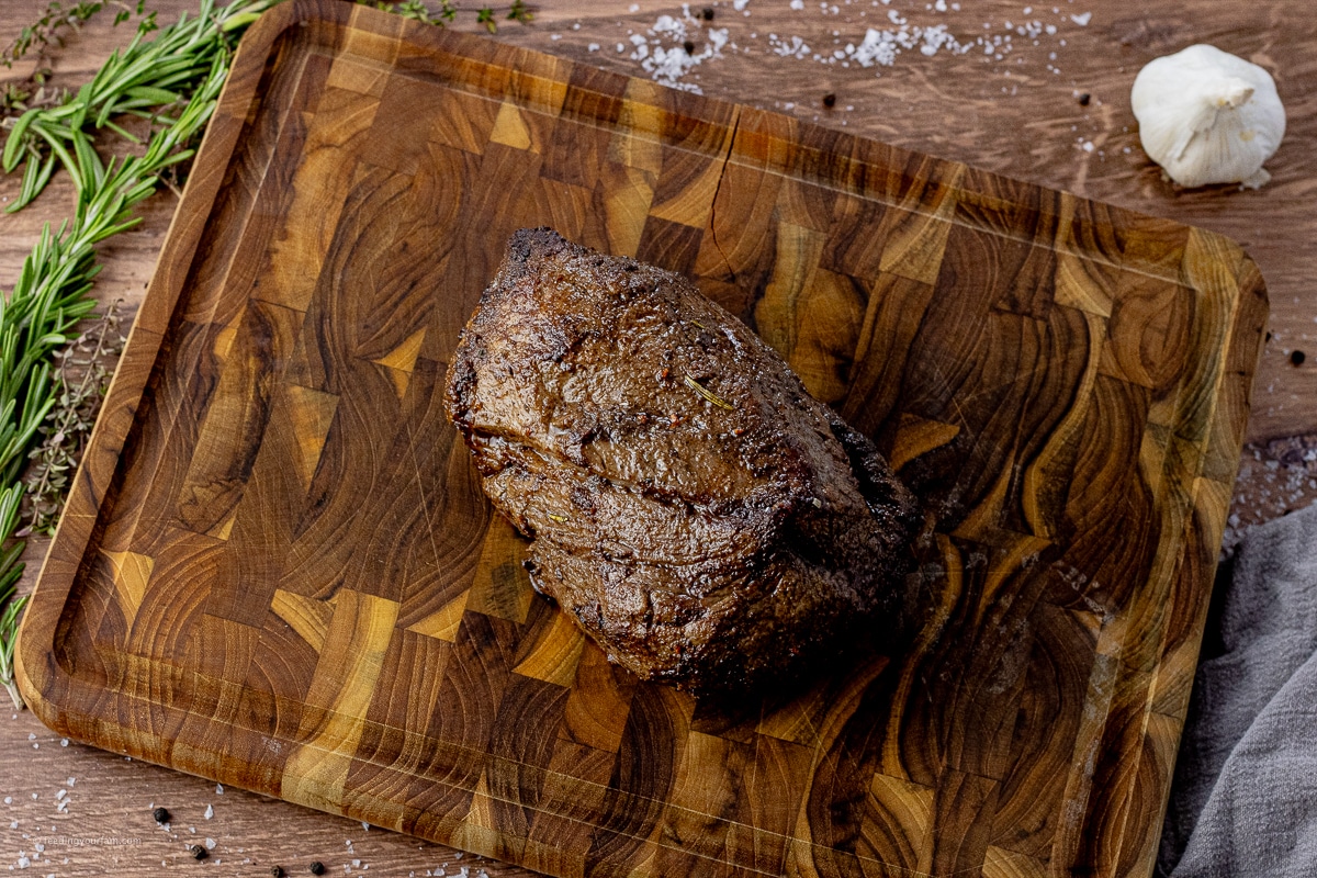 cooked beef tenderloin on a wooden cutting board