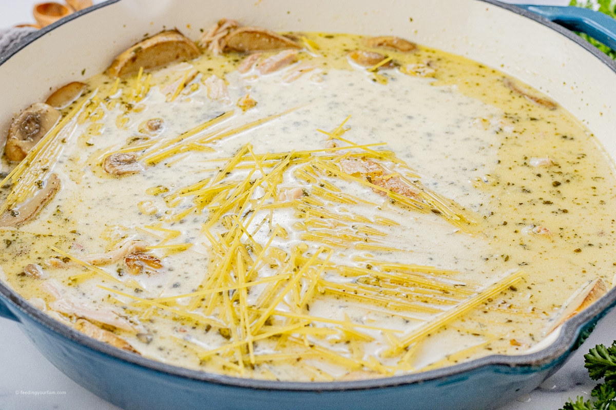 pan with uncooked pasta in cream and chicken broth