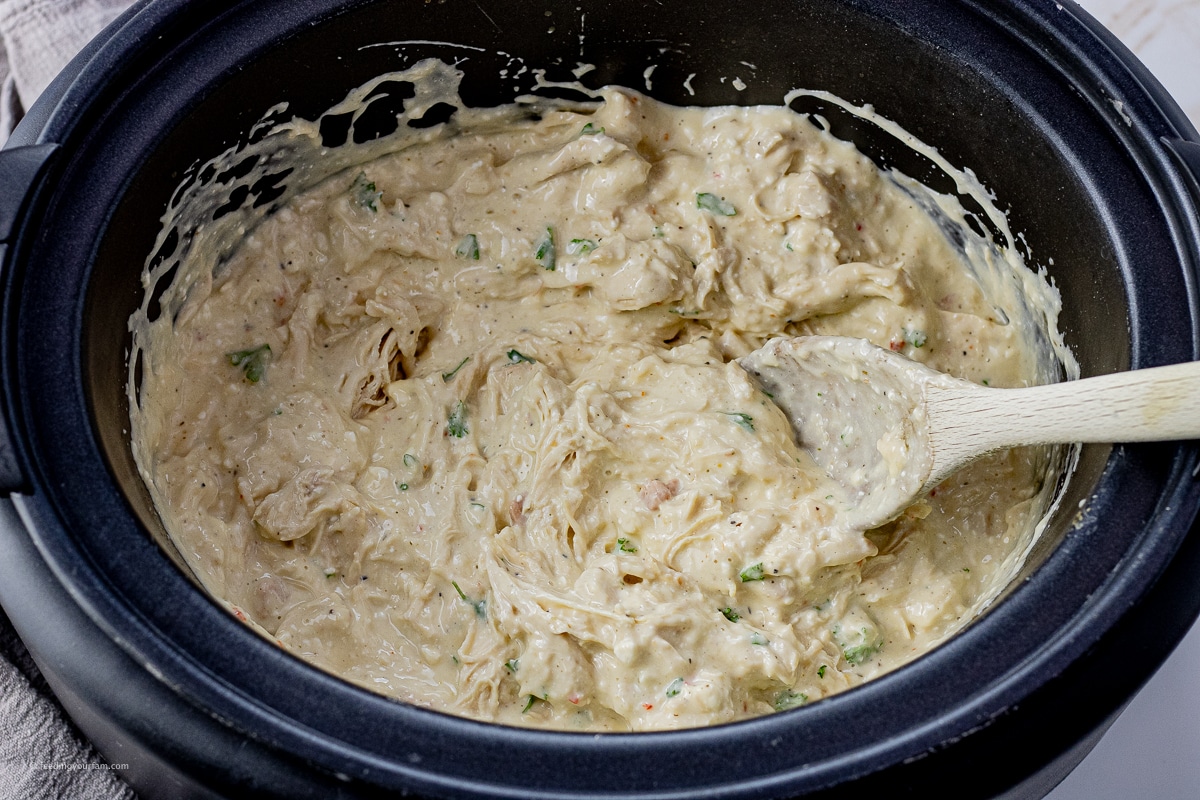 shredded chicken in a creamy sauce in a slow cooker
