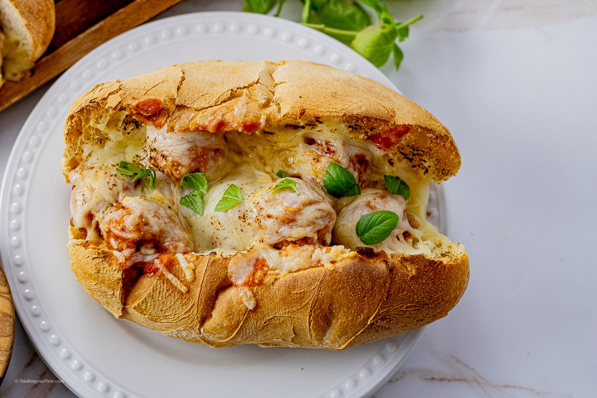 meatball sandwich in a hoagie bun topped with melted mozzarella cheese
