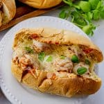 meatball sandwich topped with melted mozzarella cheese