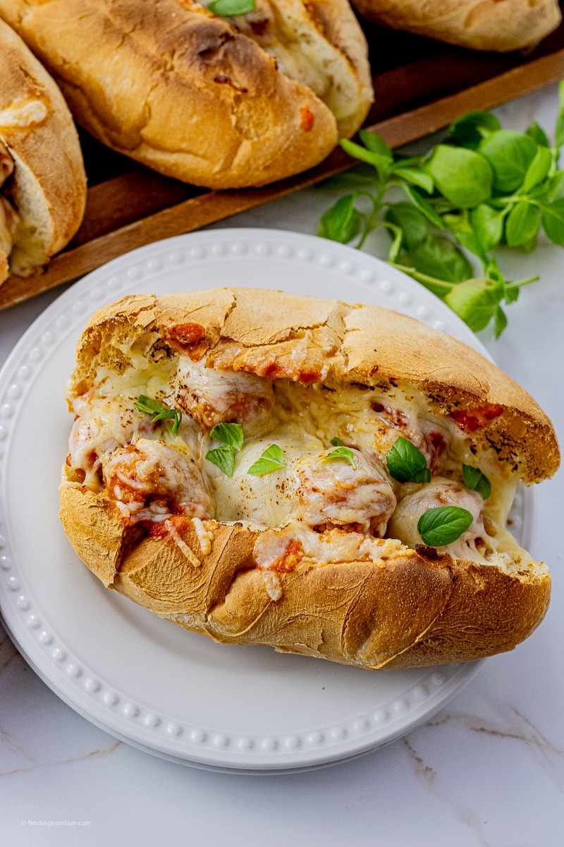 meatball sandwich in a hoagie bun topped with melted mozzarella cheese