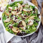 image of spinach salad with apples and dried cranberries