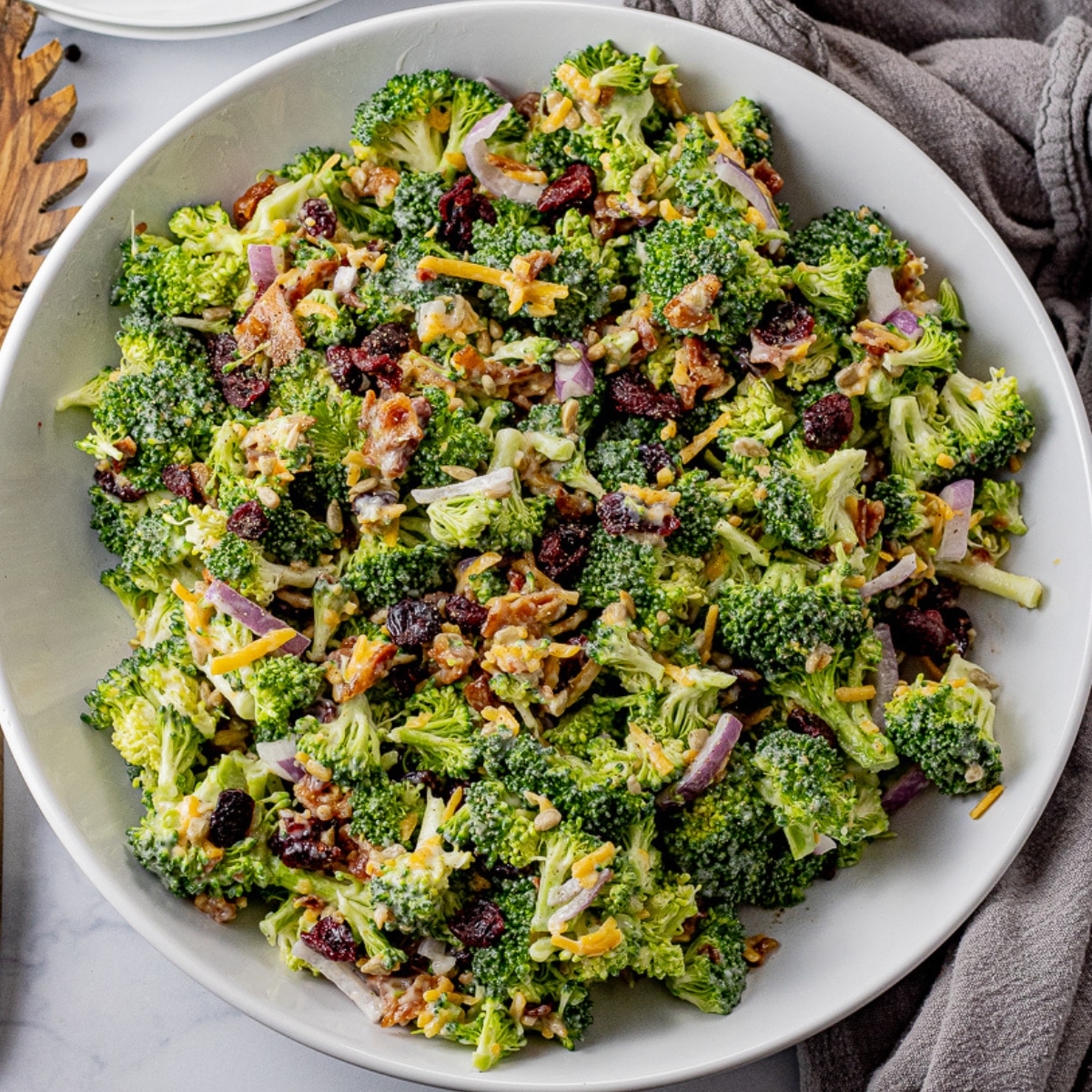 broccoli salad made with broccoli with dried cranberries, red onions and sunflower seeds