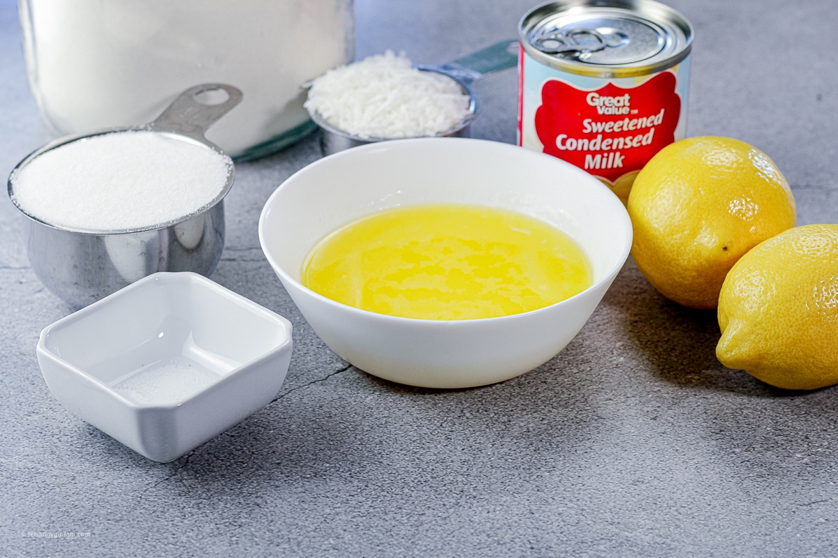 ingredients like flour, coconut, melted butter and lemon in small bowls