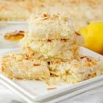 stack of lemon coconut bars on a white plate