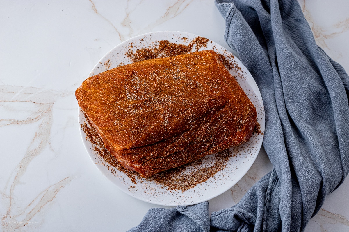 pork roast that has been rubbed with seasoning all over the outside 