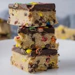 square cookie bars stacked on a white plate