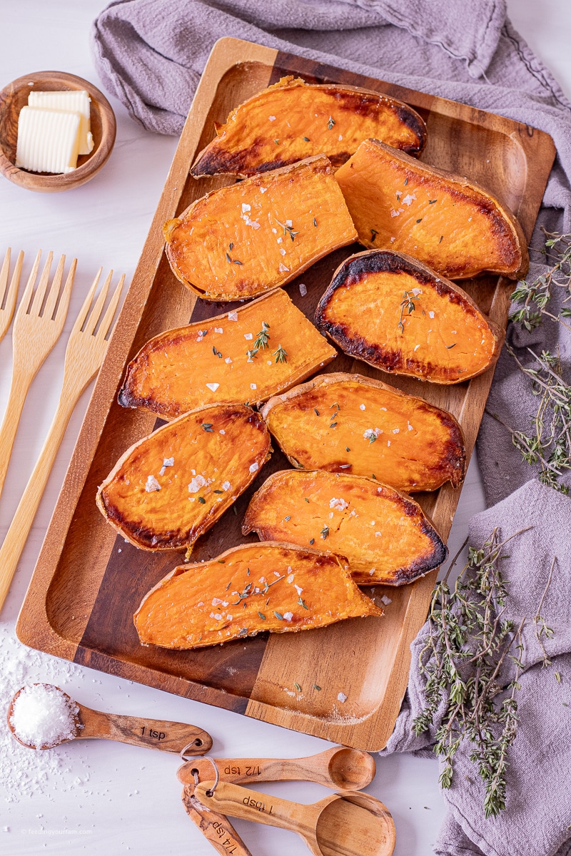 sweet potatoes that have been sliced in halves and baked in the oven on a serving platter