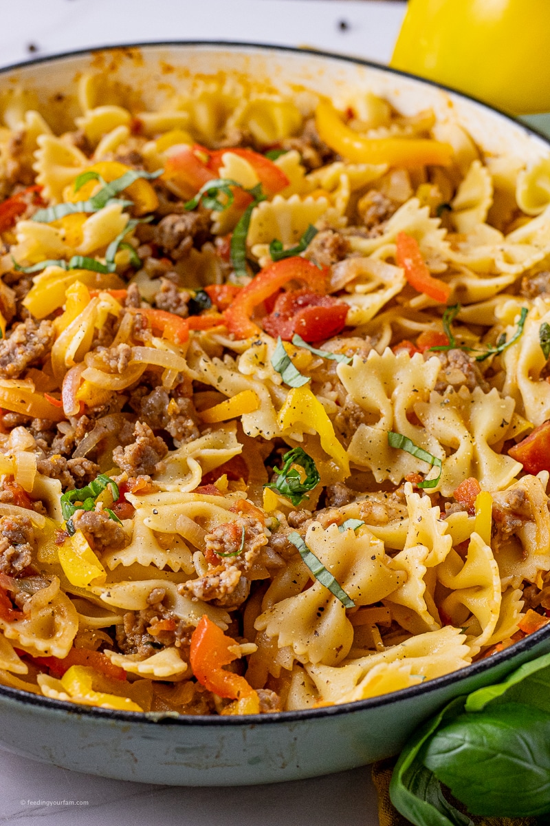 Italian sausage and pepper pasta skillet bowtie pasta with peppers, onions and sausage in a large skillet