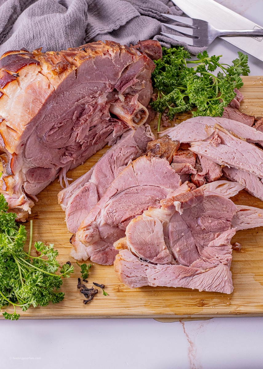 sliced ham on a wooden cutting board