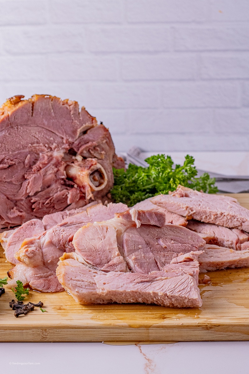 sliced ham on a wooden cutting board