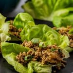 ground chicken lettuce wraps on a black plate