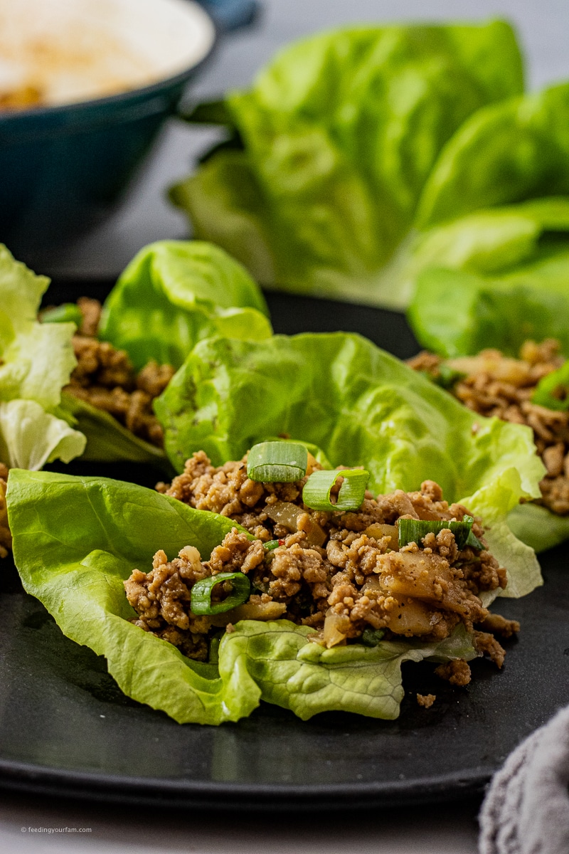 ground chicken lettuce wraps on a black plate