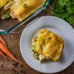 slice of chicken pot pie in crescent roll dough on a white plate