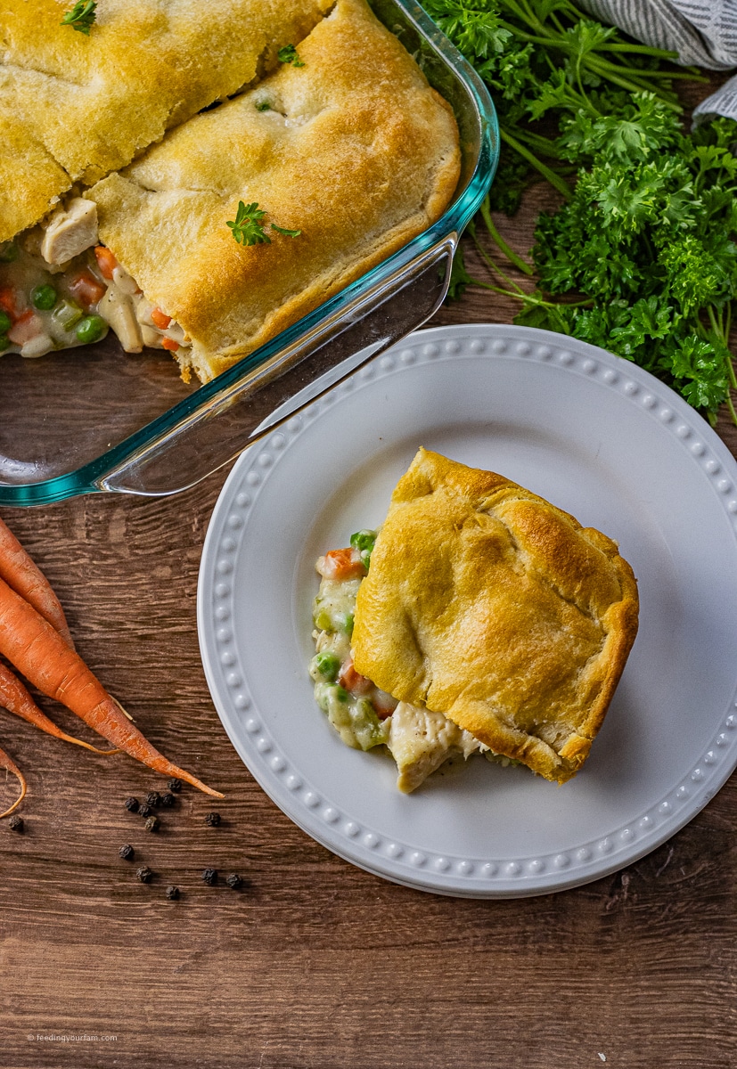 slice of chicken pot pie in crescent roll dough on a white plate