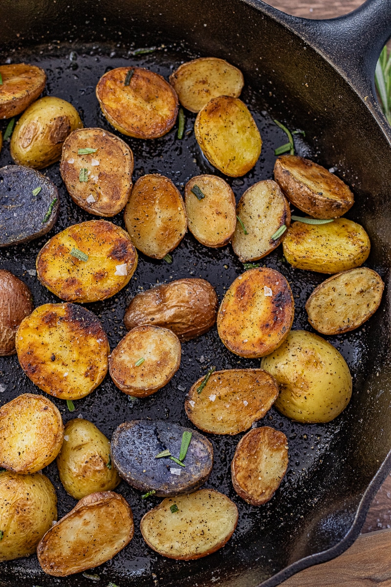 small potatoes cut in halves and cooked in a cast iron pan