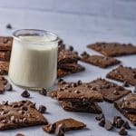square pieces of thin brownies with a small glass of milk