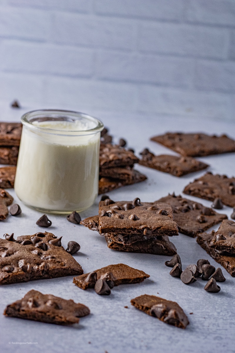 square pieces of thin brownies with a small glass of milk