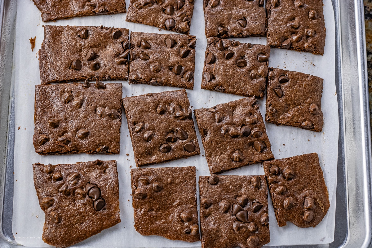 brownie brittle pieces cut into squares on a baking sheet