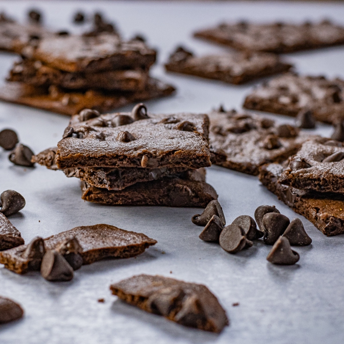 squares of brownie thins with chocolate chips on a counter top