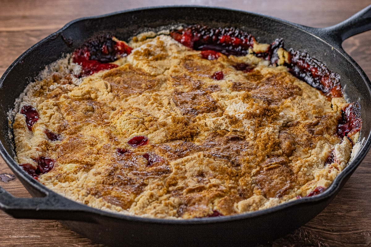 cherry pineapple dump cake baked in a cast iron skillet
