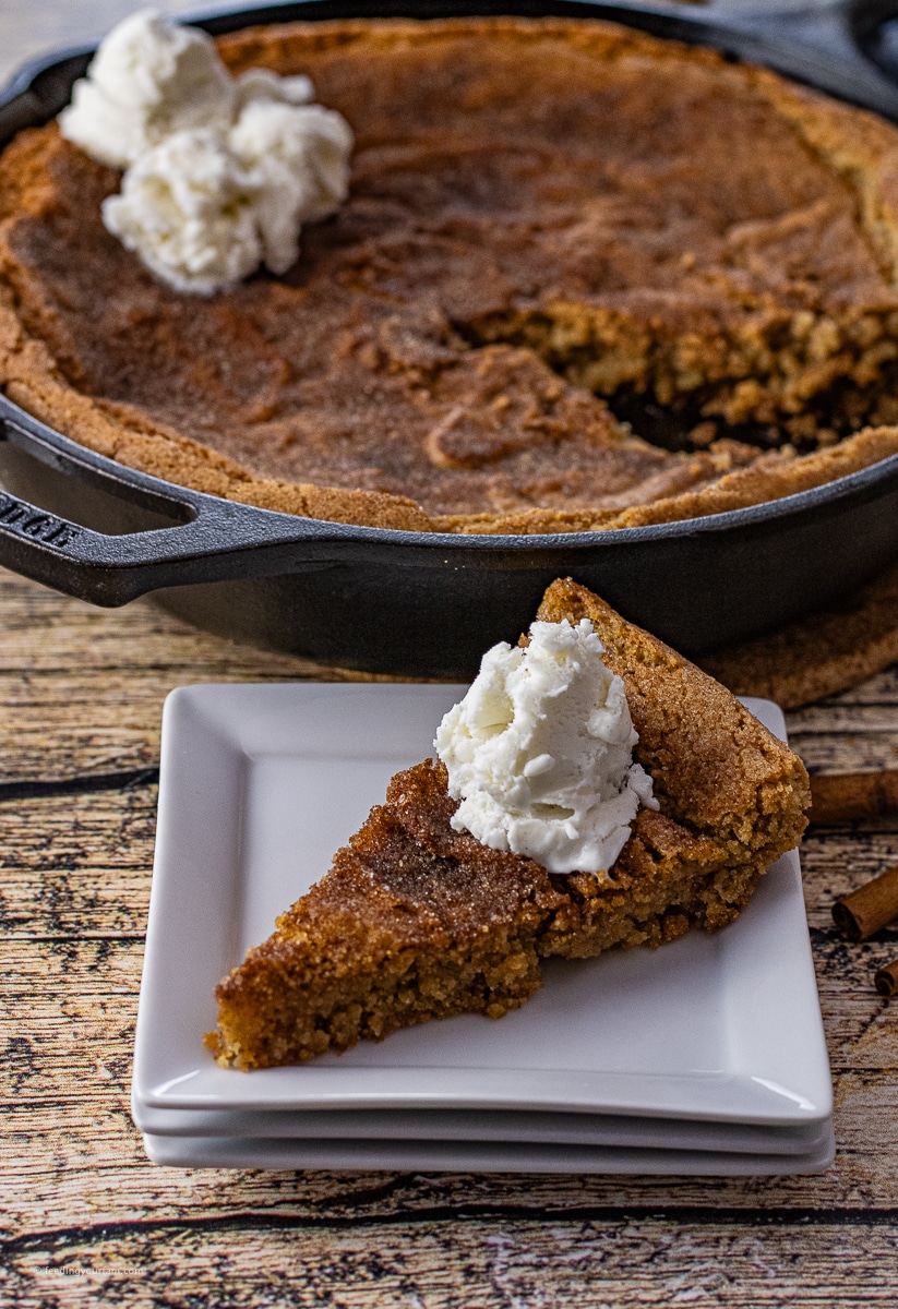 sliced piece of snickerdoodle skillet cookie on a white square plate