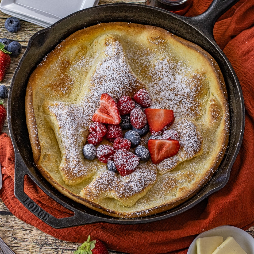 cast iron dutch baby pancake topped with fruit