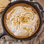 Gooey s’mores cookie baked in a cast iron skillet with toasted marshmallows and melted chocolate on top