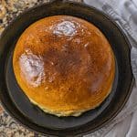 large round loaf of cast iron bread in a cast iron skillet