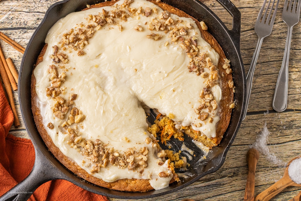skillet carrot cake with a slice out of it