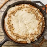 carrot cake with cream cheese frosting in a cast iron skillet