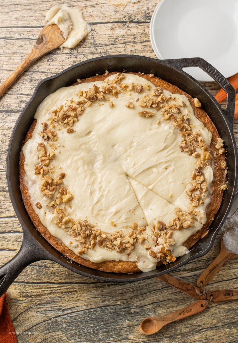 carrot cake with cream cheese frosting in a cast iron skillet